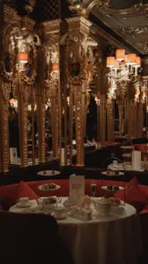 A visually elegant showcase of the David Bowie-themed afternoon tea at Hotel Café Royal, featuring close-ups of the themed pastries and the opulent dining room setting.