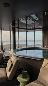 A cinematic tour of a rooftop spa in Liverpool, showcasing the jacuzzi, sauna, steam room, and cold plunge facilities with panoramic city views.