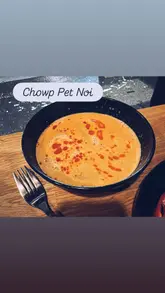 A montage video showcasing various Thai dishes including crispy pork belly and soup at Chaup Pet Noi in Glasgow, followed by a brief pan of the restaurant interior.