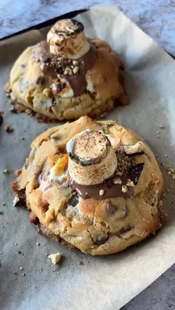 S’mores Cookies🍪

What I love about these is the crunchy biscuit base with the soft, gooey marshmallows!

Recipe (makes 8 large cookies):

125g unsalted butter
110g light brown sugar
80g granulated sugar
1 large egg
1tsp vanilla extract
300g plain flour
1.5tsp baking powder
0.5tsp bicarbonate of soda
0.5tsp salt
100g milk chocolate chips
170g chopped milk chocolate
Large marshmallows
30g mini marshmallows
Half chocolate covered biscuits
Extra milk chocolate for topping (optional)

1. Add the unsalted butter and both sugars to a large bowl and whisk together until well combined.
2. Add the egg & vanilla extract and beat again.
3. Then add the flour, baking powder, bicarbonate of soda & salt and at this point I swapped over to my paddle attachment and mixed until well combined.
4. Add in the chocolate chips, chocolate chunks & mini marshmallows and use your hands to combine the cookie dough and chocolate.
5. Roll into roughly 120g balls.
6.Open up the cookie dough ball and put one large marshmallow inside and wrap it up again.
7.Cut a small edge off the biscuits and then place one (biscuits side facing down) under the cookie dough ball and blend the dough around the edges of the biscuit.
8.Freeze for at least 30 minutes - I waited 2 hours. Or keep in a freezer bag and just cook them when you want them!
7. Preheat your oven to 180 fan.
8. Line a baking tray with baking paper and spread them out, I did 4 per tray.
9. Bake for 15-20 minutes until lightly golden and leave to cool at room temperature.
10.Melt some chocolate and spread on top. Add a marshmallow on top and torch it. Enjoy!

#smorescookies #cookierecipe #bristolfoodie #chunkycookies #smores
