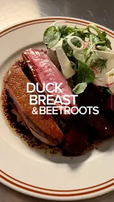 A cooking tutorial video demonstrating how to prepare duck breast with beetroot, horseradish cream, and a winter salad.