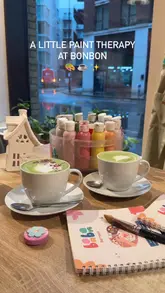 A short, aesthetic montage showcasing a pottery painting session at a cafe. The video follows the process from selecting a ceramic piece to painting it, while enjoying a matcha latte, and concludes with the finished items.