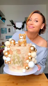 A creator announces the return of her custom cake business by showcasing a baby shower cake and matching cupcakes she created for a client.