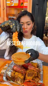 A high-energy, creator-led review of a seafood boil restaurant in London, showcasing the messy, indulgent food including seafood boils, burgers, and loaded fries.