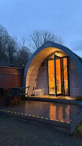 A short, personal-style vlog showcasing a weekend stay at a glamping site. The video features the interior of the pod, the surrounding nature, a walk by a lake, and the group of friends relaxing and eating together.