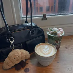 Two friends enjoying matcha and coffee at Tabitha's Coffee in Manchester.