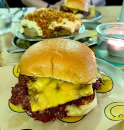 Delicious dishes at Whole Beast in Brixton, including award-winning burgers and unique sides like dripping hash browns.