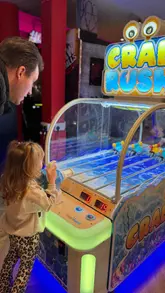 A family-focused vlog documenting a day out at a venue featuring bowling, arcade games, and a Pan-Asian restaurant. The video transitions from the activity area to a sit-down meal, highlighting the variety of experiences available under one roof.