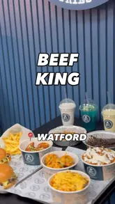 A montage-style video showcasing the menu at Beef King in Watford, featuring close-ups of burgers, loaded fries, wings, desserts, and mocktails, alongside brief shots of the restaurant interior.