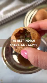 A short, punchy video demonstrating the assembly and consumption of pani puri, focusing on the texture and the 'pop' of the snack.