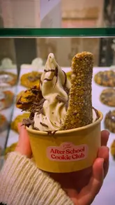 A short, engaging video showcasing an edible spoon used to eat a cookie and ice cream dessert at The After School Cookie Club.