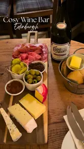 A short, atmospheric video showcasing 'Pickles', a wine bar in Edinburgh. The video features shots of the exterior, the cosy interior, and a meat and cheese board, accompanied by text overlays describing the venue as an Edinburgh institution.