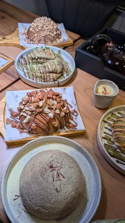 Food bloggers enjoying delicious desserts at Papparoti in Blackburn, showcasing delightful treats and vibrant atmosphere.