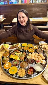 A promotional video for Patri in Ealing, showcasing their large Indian thali platter designed for sharing. The video features close-ups of various dishes, including chaats, curries, and desserts, alongside shots of the creator and a child enjoying the meal.
