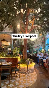 Lunch at The Ivy Liverpool featuring chicken skewers, fishcake, and prosecco in a chic setting.