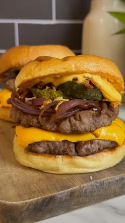 Delicious Philly Cheese Stack Burger with double beef, melty cheese, and onions, perfect for high-protein meal lovers.