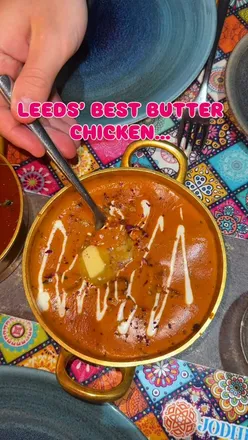 Delicious butter chicken with melting butter, poppadoms, and lamb curry at Jodhpur in Leeds, perfect for spice lovers!