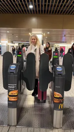 Traveler relaxing on the Stansted Express train to the airport, enjoying comfortable seating and free Wi-Fi.