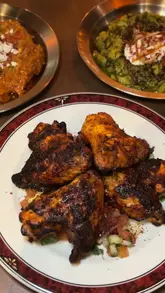 Delicious Persian dishes at Kuch, a family-run restaurant in Bristol, featuring king prawns, smoked aubergine dips, and lamb shoulder.