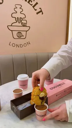 Delicious warm cookies dipped in flowing chocolate at Cocomelt in London, a dessert lover's dream experience.