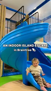 A short video showcasing a soft play cafe in Braintree, featuring a child playing in the ball pit and on the slide, alongside a shot of a pink lemonade drink.