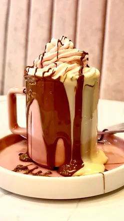 Decadent desserts at Moo London, Cardiff, featuring triple chocolate cake and strawberry cream shakes.