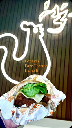 Delicious Popeyes chicken wrap, burger, and mac & cheese at the new Llanelli store opening, showcasing tasty comfort food.