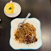 Beef ho fun and mango steamed milk pudding at Four Happiness & Sweet Honey Desserts in Leeds, showcasing authentic Cantonese cuisine.