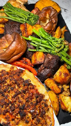 Sunday roast feast at Oxwich Bay Hotel in South Wales, featuring beef, chicken, and decadent desserts by the beach.