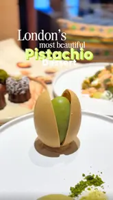 The video features a series of high-quality, close-up shots of intricate plated desserts and specialty drinks at Qima Cafe. It highlights the signature pistachio dessert, a tiramisu cold brew, and various caneles, emphasizing the refined presentation and the collaboration with a Michelin-starred pastry chef.