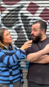 A short-form video featuring a street interview to find a local food recommendation, followed by a visit to 'Moo Moo' to review their wagyu and brisket burger and loaded fries. The creator provides a positive review, highlighting the quality of the beef and the flavour of the sides.