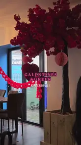 A montage-style video showcasing a Greek restaurant, featuring shots of the menu, Valentine's-themed interior decor, and various dishes including dips, pita, souvlaki, and a mixed grill.