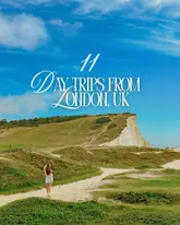 Scenic view of rolling green hills and quaint village cottages in the UK countryside, a perfect day trip from London.