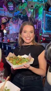 A creator visits The Happy Fish, a vegan and gluten-free chippy located inside The Dog House in Edinburgh, to try their new non-gluten-containing menu. The video features cocktails, various chippy staples like haggis, frickles, pizza crunch, and a deep-fried Mars bar.