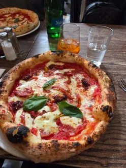 Enjoying Neapolitan pizza and tiramisu at Fatto a Mano, with 5 locations in London for a perfect meal out.