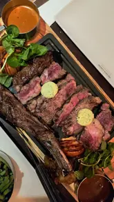 A perfectly cooked Côte de Boeuf sharing steak and Soy & Mirin Pork Belly at Miller & Carter Thornhill, Cardiff.