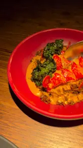 Smoked jollof rice with native lobster tail, perfectly cooked and presented at Ikoyi London.