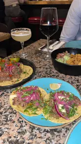 A montage-style review of a date night at Temper City, showcasing the open-fire kitchen, cocktails, tacos, steak, and dessert.
