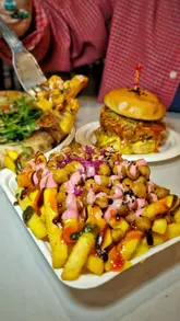 A spread of street food: burger, pad thai, pizza, fries & ravioli from independent traders at Newport Market food hall.