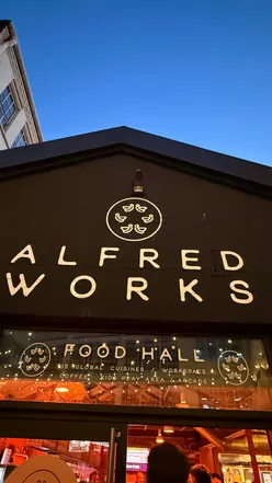Diners enjoying diverse global cuisines from 15 independent food partners at Alfred Works food hall in Birmingham's Custard Factory.
