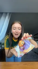 A creator visits a unique 'doughnut shed' in Trimsaran, Wales, which operates on an honesty box system. She showcases the variety of doughnuts available, selects a blueberry muffin doughnut, and provides a taste test review at home.