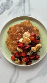 Crispy chicken schnitzel with blistered tomato caprese salad, cooked in a Ninja Crispi Pro. Perfect for hosting season.