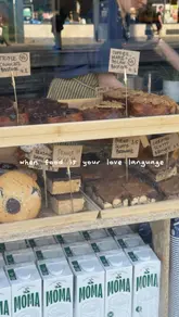 A personal vlog-style reel documenting a visit to Babyfaced Baker in Edinburgh. The creator captures the exterior of the shop, the interior display of various baked goods, and the takeaway boxes purchased, providing a glimpse into the bakery's atmosphere and product range.