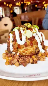 Diners enjoying small plates and roasts like mushroom wellington in the cosy, European-inspired Schillers Hall restaurant, Liverpool.