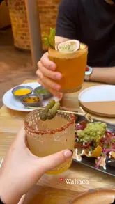 A short, energetic reel featuring a visit to Wahaca, highlighting their cocktails and Mexican dishes like tacos and loaded nachos. The video uses a handheld, vlog-style approach to capture the dining experience with a friend.