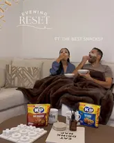 A lifestyle-focused social media post featuring a couple at home during an 'evening reset', incorporating face masks and KP Nuts as part of their relaxation routine.