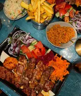 Here are a few options for your SEO alt text, keeping under the 125-character limit:

**Option 1 (Descriptive):**
Delicious mixed grill platter with lamb, kebabs, and chicken at Veyso’s restaurant in Hertford.

**Option 2 (Action-focused):**
A loaded mixed grill with juicy meats and crispy sides served at Veyso’s in Hertford, Hertfordshire.

**Option 3 (Keyword-focused):**
Close up of a premium mixed grill platter featuring smoky kebabs and chicken at Veyso's Hertford restaurant.

**SEO Tip:** Option 1 is generally the best for accessibility and search engines as it clearly defines what is in the image and where the business is located.