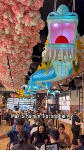 A short, vlog-style review of Maki & Ramen in Nottingham, featuring shots of the restaurant's distinctive dragon decor, the menu, and a variety of Japanese dishes including ramen, sushi, and sashimi.