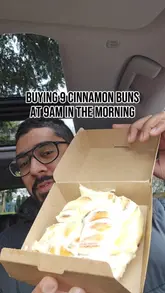 A creator reviews cinnamon buns from Frankie's Bakery, sharing his experience of queuing early in the morning to purchase them. He provides a taste test and commentary on the texture and flavour of the buns, while also briefly showing the bakery's display case.