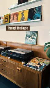 A short video showcasing the interior, coffee, and vinyl record collection of a cafe called Through The House in Glasgow.